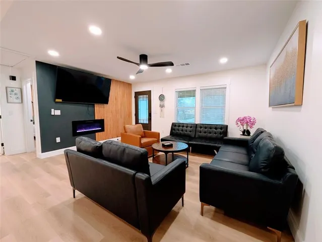 a living room with furniture window and a flat screen tv