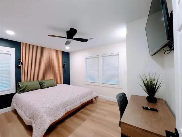 a bedroom with a bed and a flat screen tv