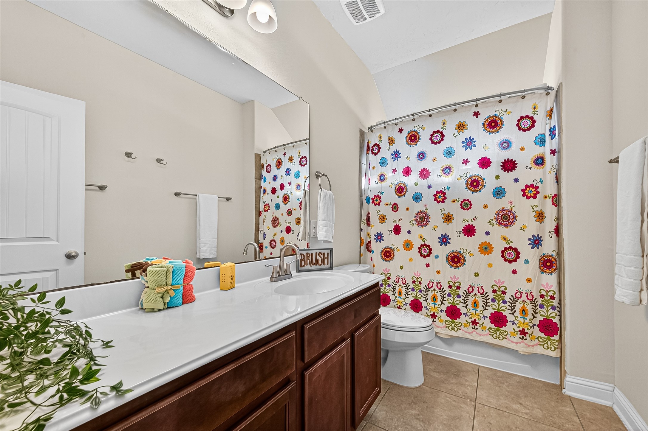 8107 Lockridge Terrace Lane Cypress, TX 77433 - Photo 40 of 50 This wonderful secondary bathroom is full of comfort and space! You'll love the extra-long vanity, offering ample counter space and rich cabinetry for all your storage needs. It’s the perfect, functional layout for busy mornings, visiting guests, or a relaxing evening bath. Clean, bright, and move-in ready, this space is designed for easy living.