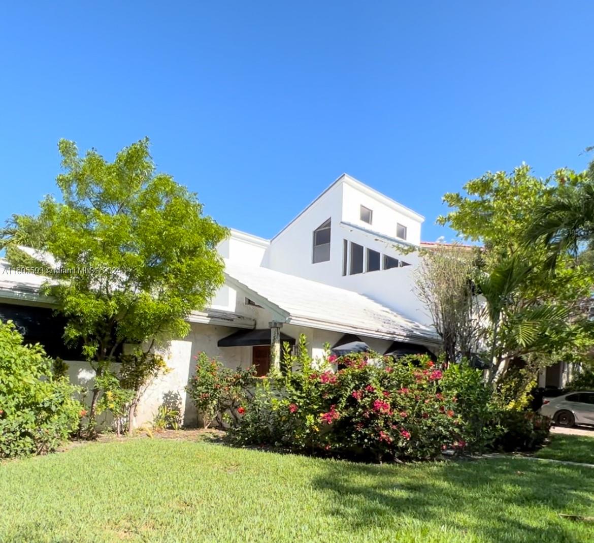 412 Woodcrest Road Key Biscayne, FL 33149 - Photo 1 of 1 a front view of a house with a yard