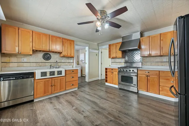 a kitchen with stainless steel appliances granite countertop a stove and a sink