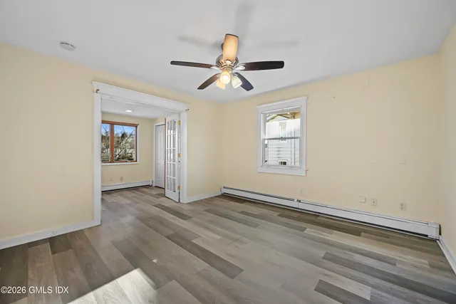 wooden floor in an empty room with a window