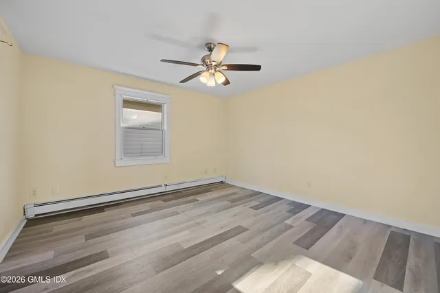 a view of empty room with ceiling fan