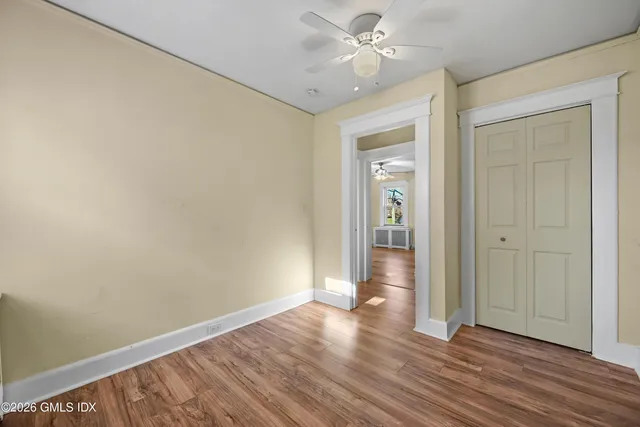 a view of an empty room with wooden floor