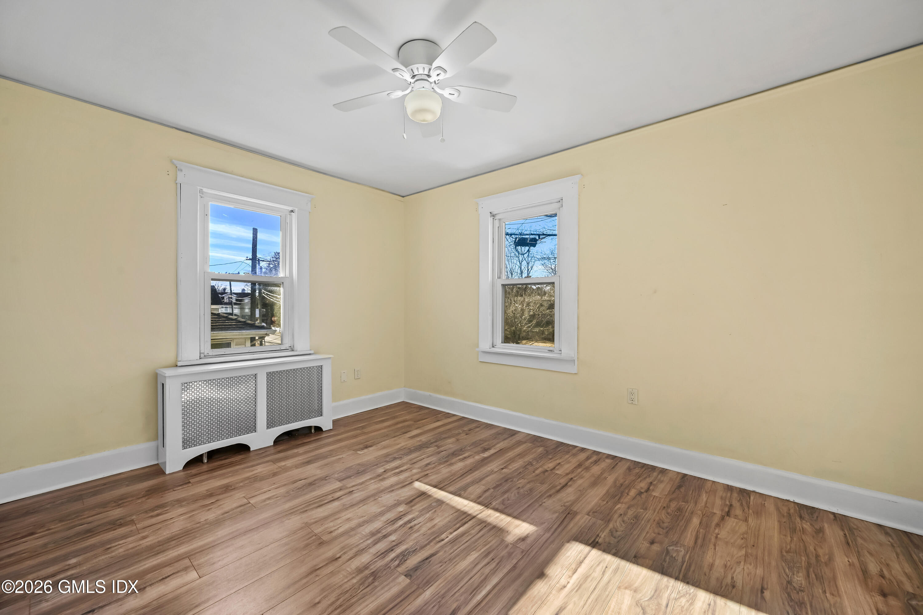 11 Bible Street Cos Cob, CT 06807 - Photo 15 of 25 a view of an empty room with window and wooden floor