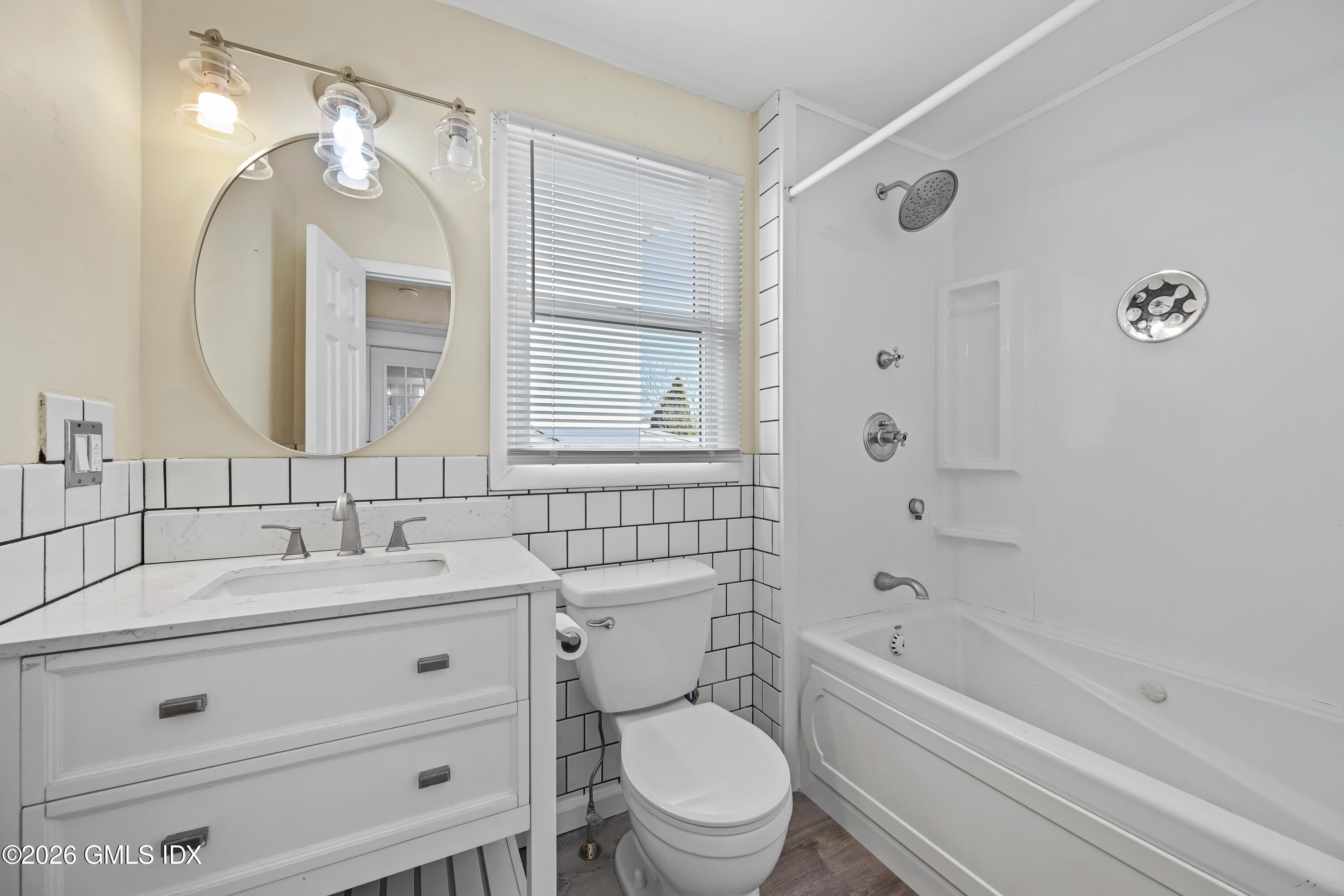 11 Bible Street Cos Cob, CT 06807 - Photo 16 of 25 a bathroom with a sink a toilet and a mirror