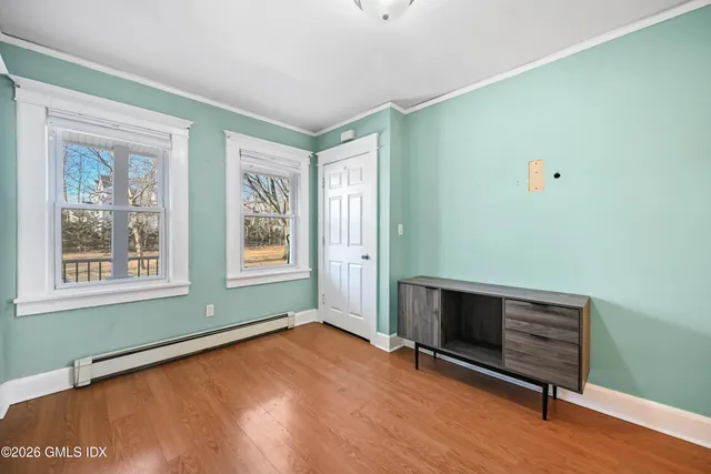 a view of room with hardwood floor and window