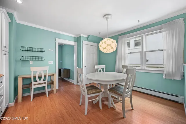 a view of a dining room with furniture window and wooden floor