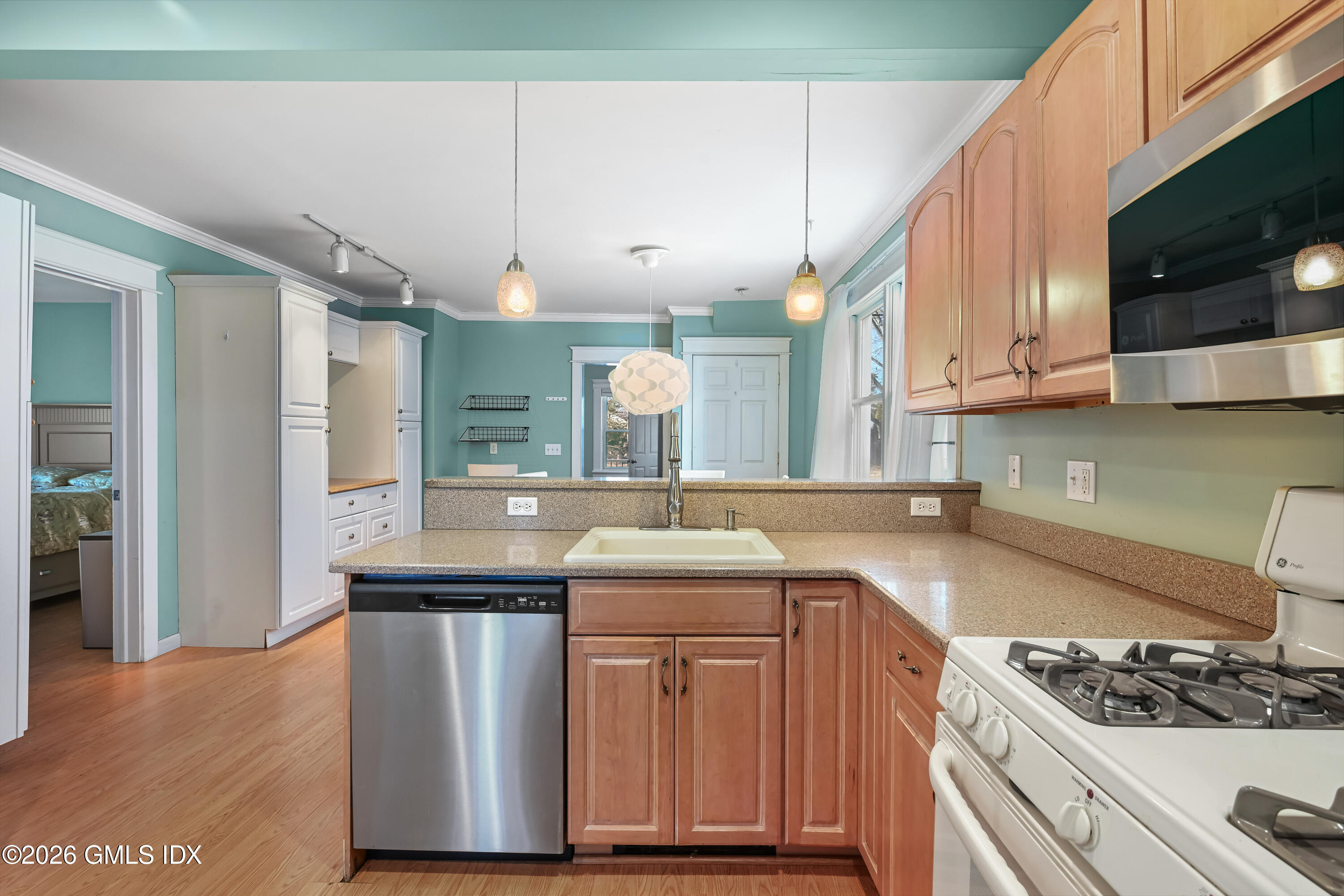 11 Bible Street Cos Cob, CT 06807 - Photo 7 of 25 a kitchen with stainless steel appliances granite countertop a sink stove and cabinets