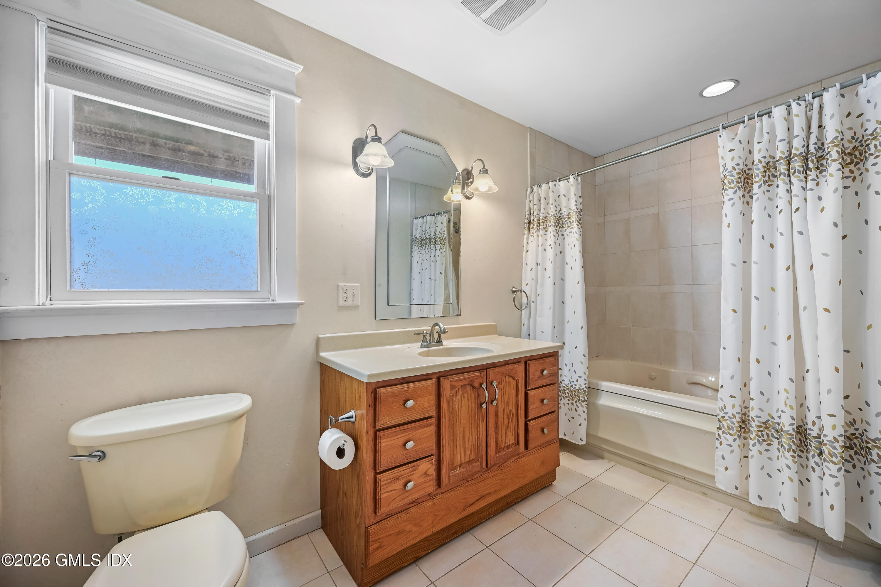 11 Bible Street Cos Cob, CT 06807 - Photo 9 of 25 a bathroom with a granite countertop toilet a sink and a mirror