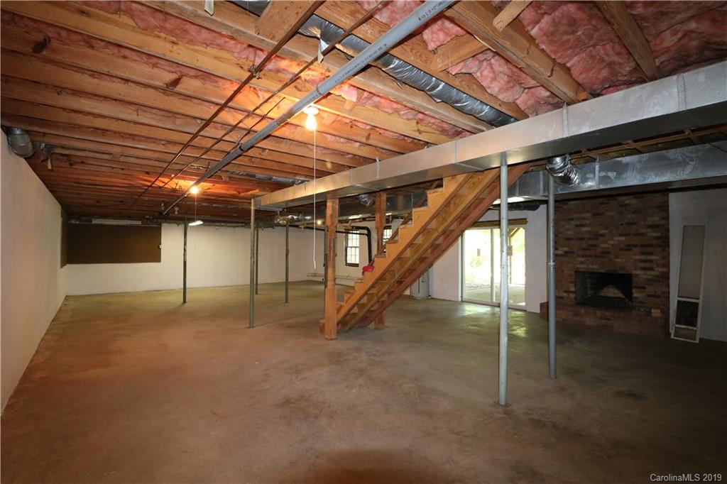 2302 Goldmine Road Monroe, NC 28110 - Photo 22 of 27 a view of an empty room with a fireplace