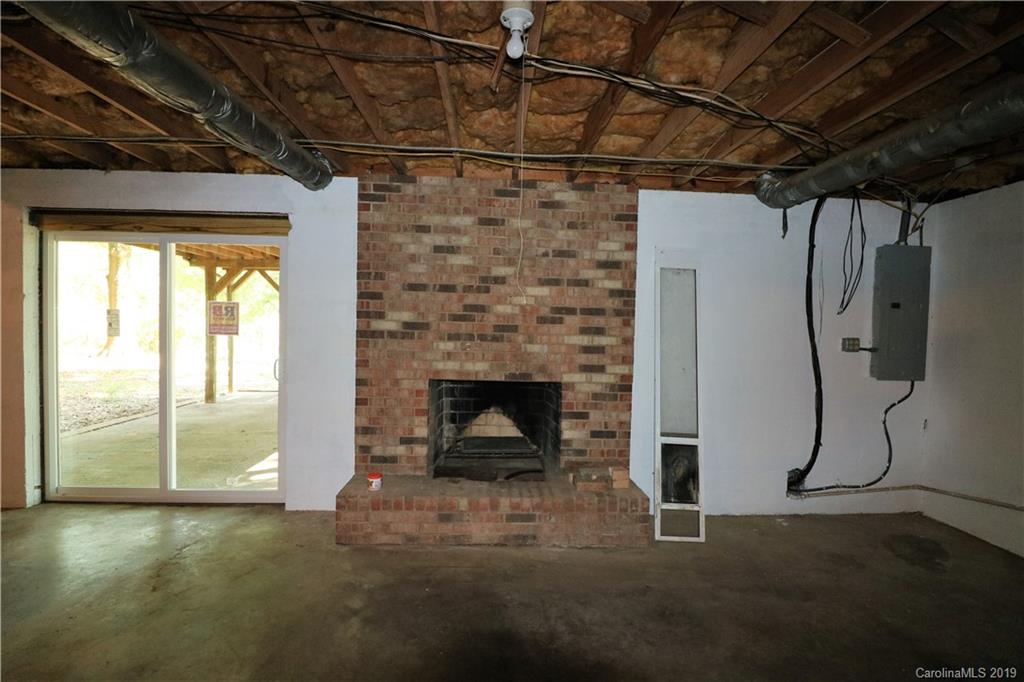 2302 Goldmine Road Monroe, NC 28110 - Photo 23 of 27 a living room with a fireplace