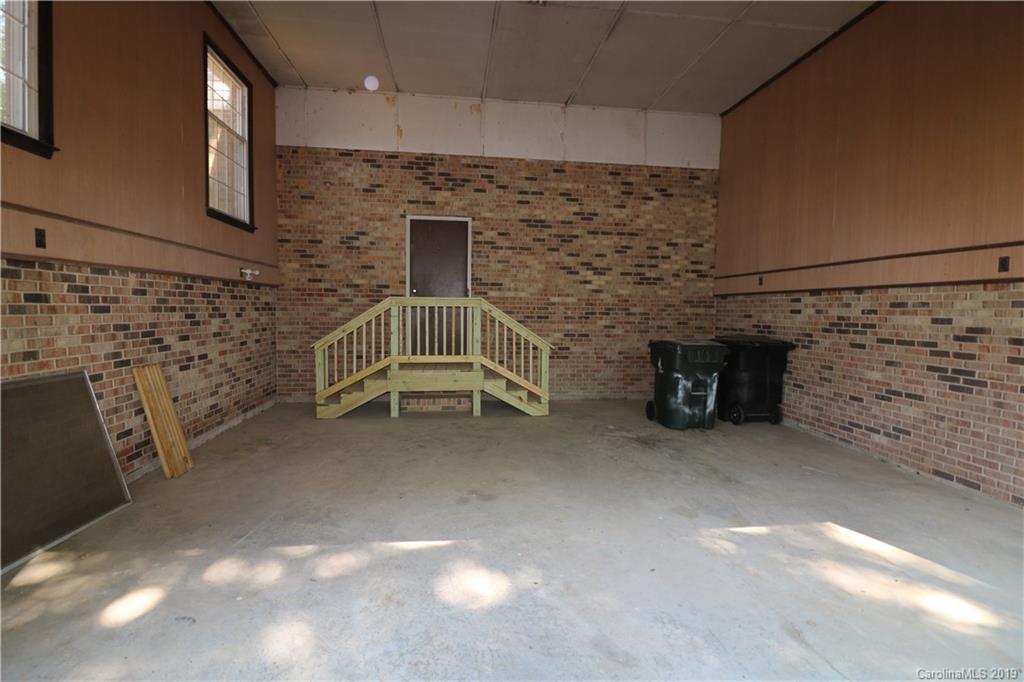2302 Goldmine Road Monroe, NC 28110 - Photo 5 of 27 a view of an empty room with brick walls