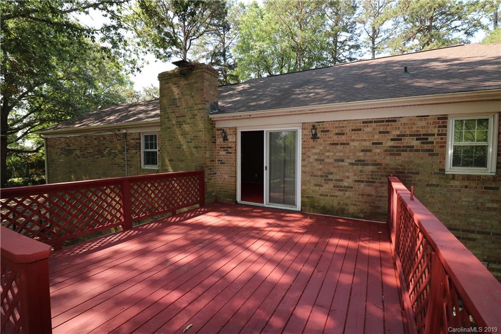 2302 Goldmine Road Monroe, NC 28110 - Photo 7 of 27 a view of a backyard with wooden fence and large trees