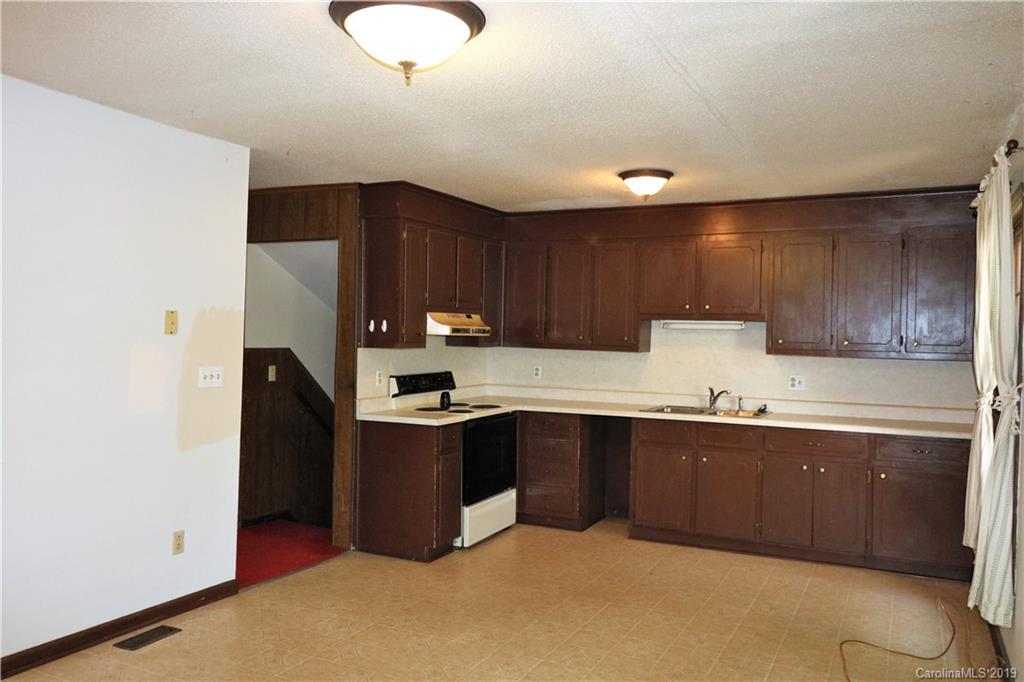 2302 Goldmine Road Monroe, NC 28110 - Photo 10 of 27 a kitchen with cabinets a sink and stainless steel appliances