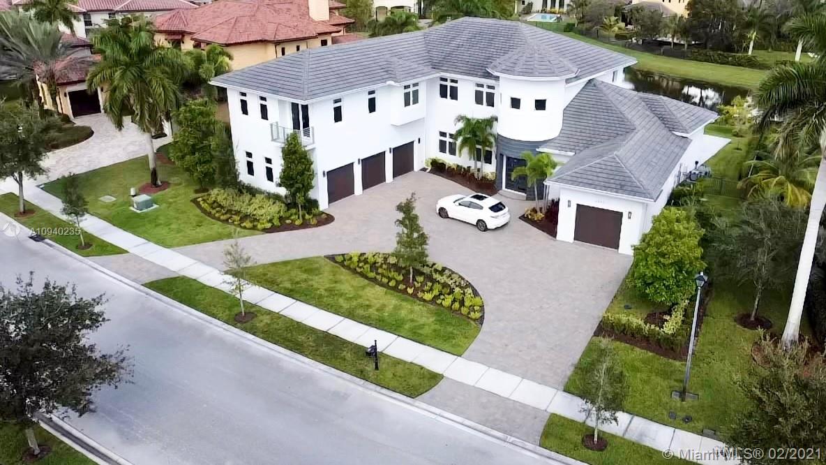 an aerial view of house with yard and green space