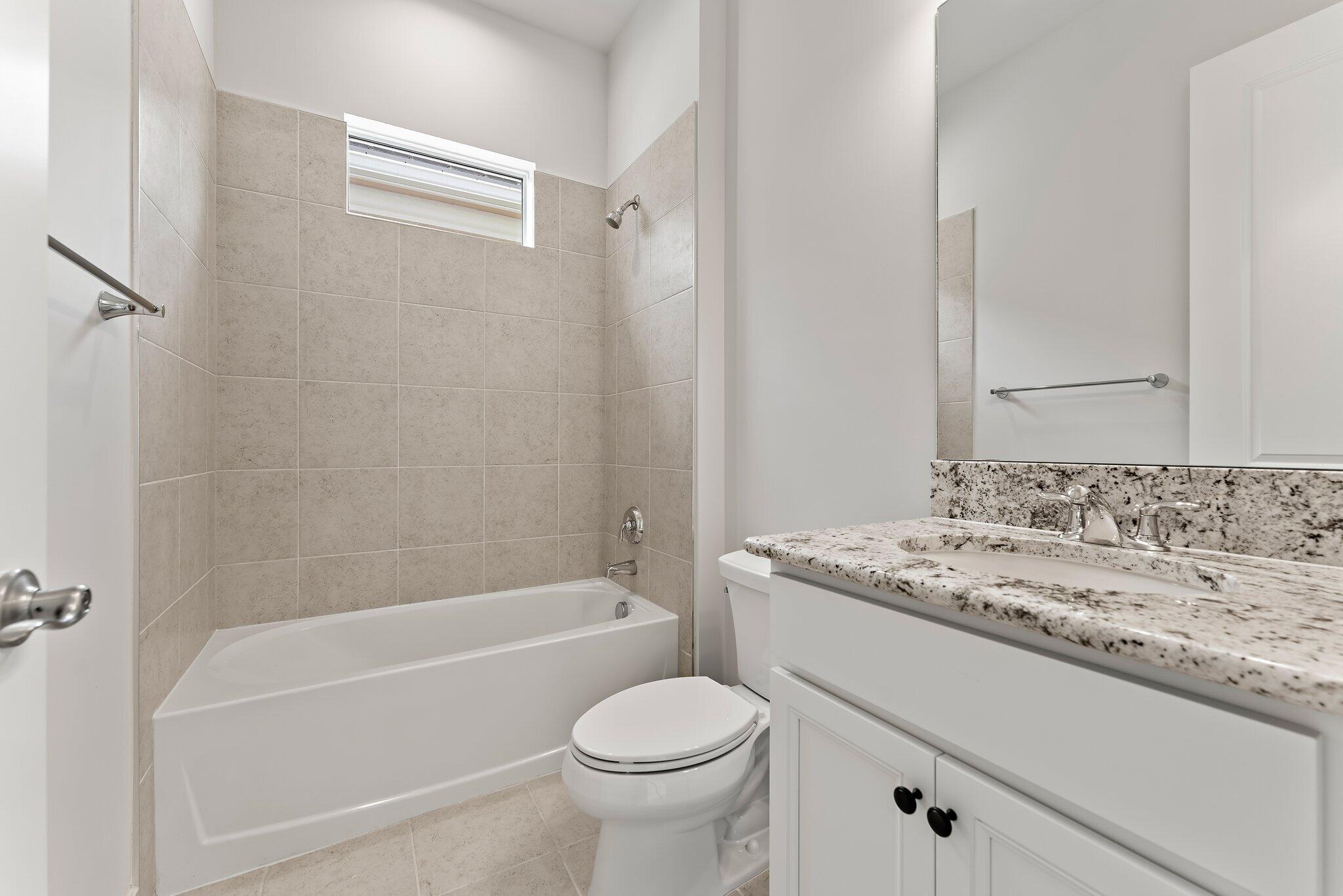 12622 Nautilus Circle Palm Beach Gardens, FL 33412 - Photo 22 of 66 a bathroom with a sink toilet vanity and shower