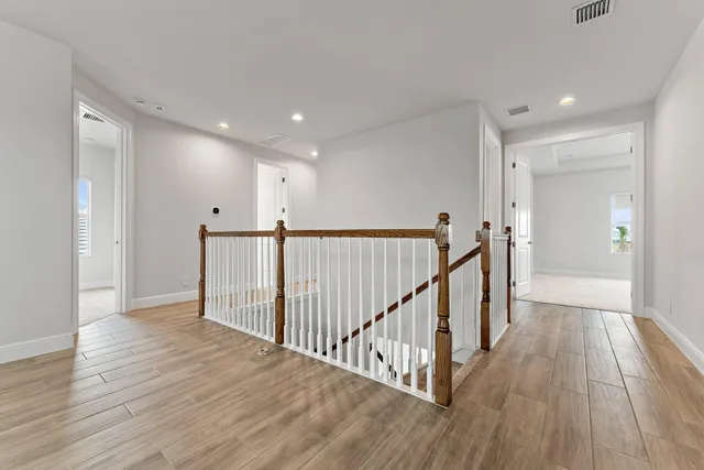 a view of an empty room with window and closet area