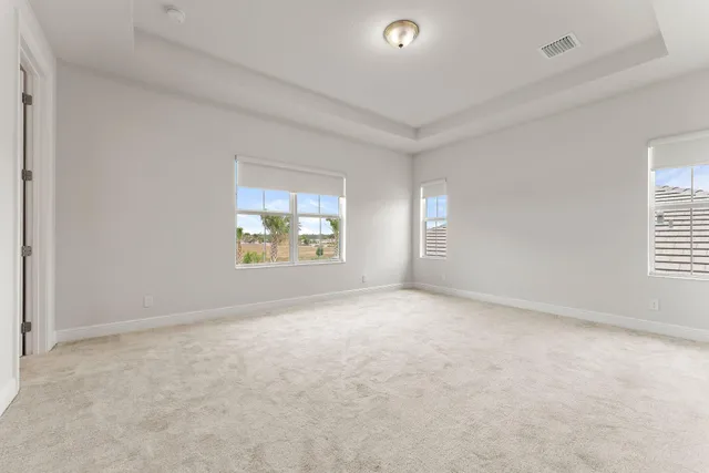 a spacious bathroom with a granite countertop sink mirror and shower