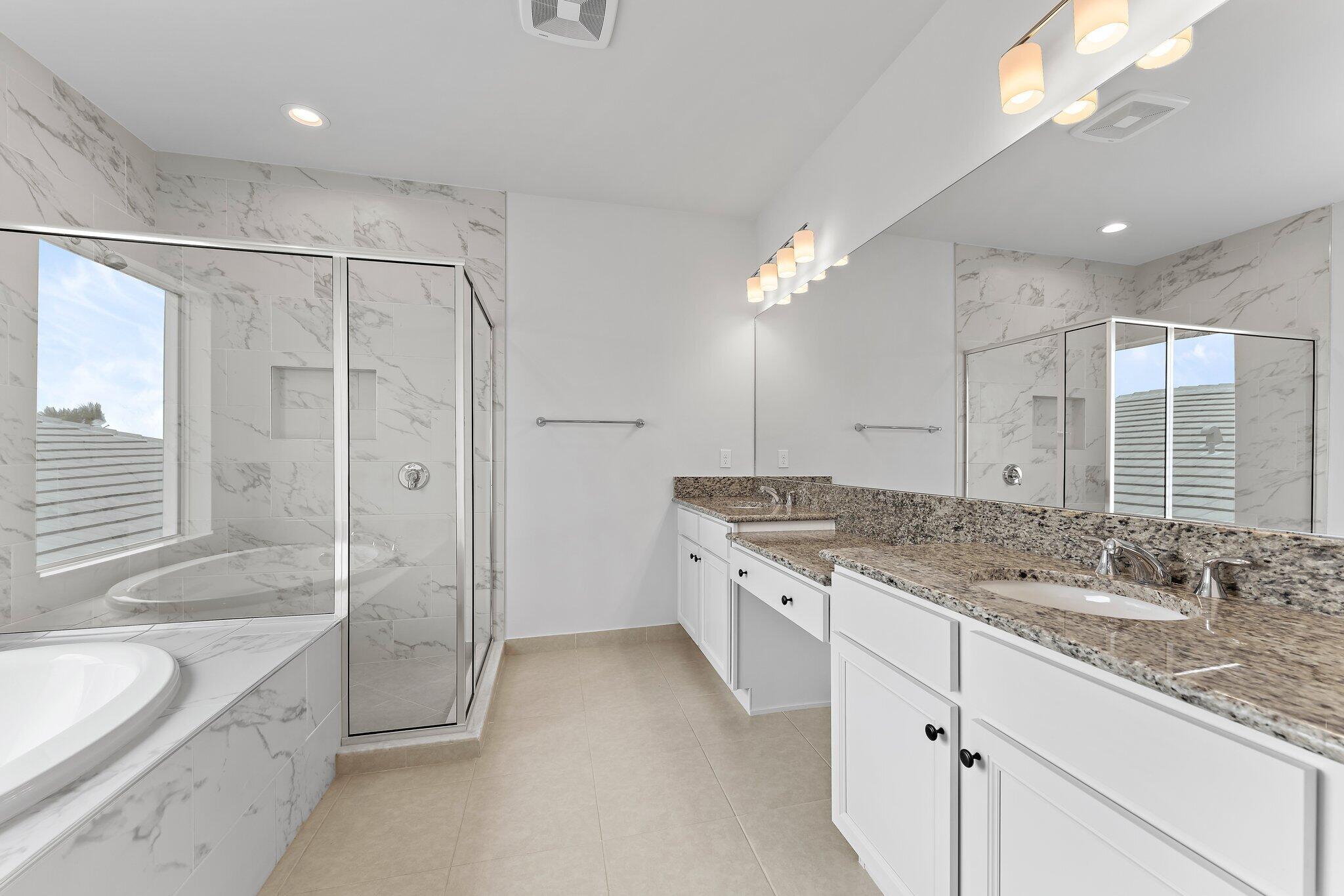 12622 Nautilus Circle Palm Beach Gardens, FL 33412 - Photo 30 of 66 a spacious bathroom with a granite countertop sink mirror and shower