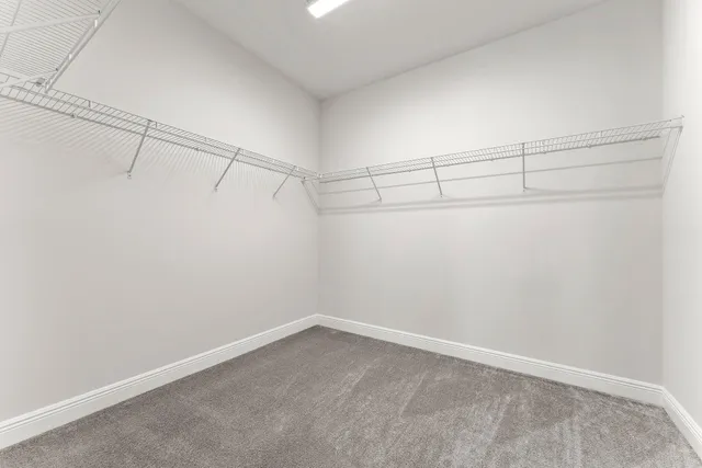 a bathroom with a granite countertop sink a toilet and mirror