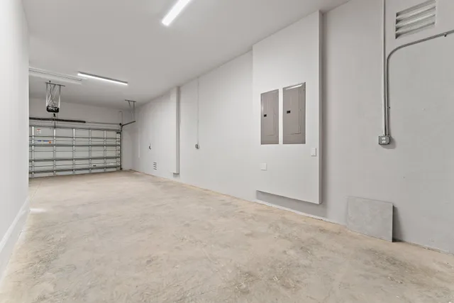 an aerial view of a house with garden space and a patio