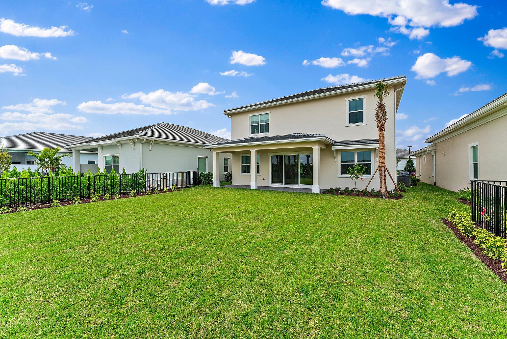12622 Nautilus Circle Palm Beach Gardens, FL 33412 - Photo 46 of 66 a front view of a house with a yard