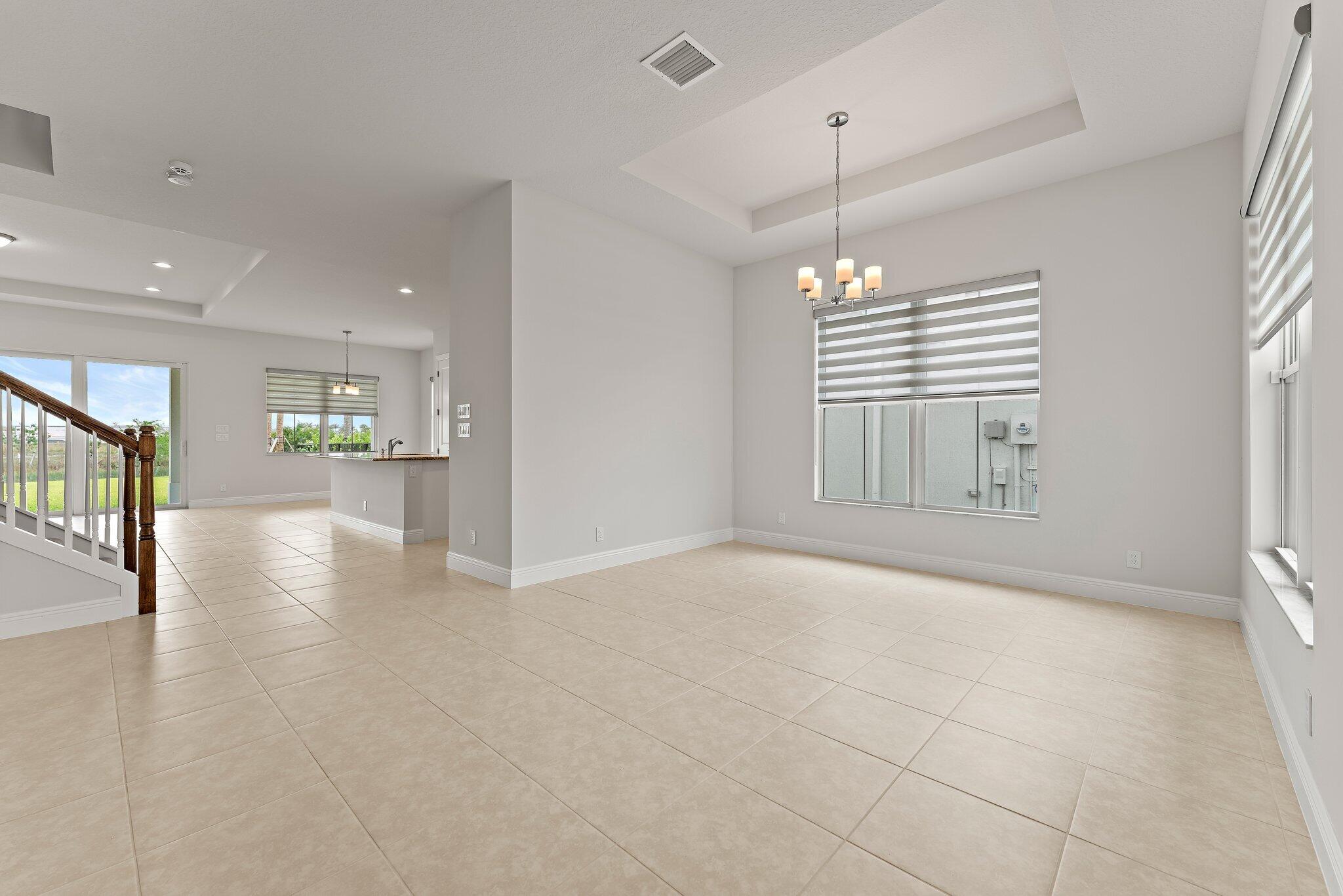12622 Nautilus Circle Palm Beach Gardens, FL 33412 - Photo 6 of 66 a view of an empty room with window and wooden floor
