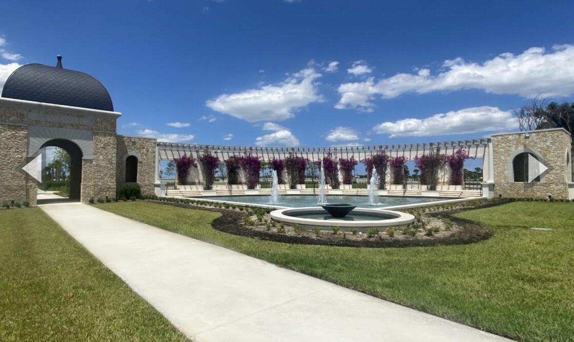 12622 Nautilus Circle Palm Beach Gardens, FL 33412 - Photo 63 of 66 a front view of a house with a yard