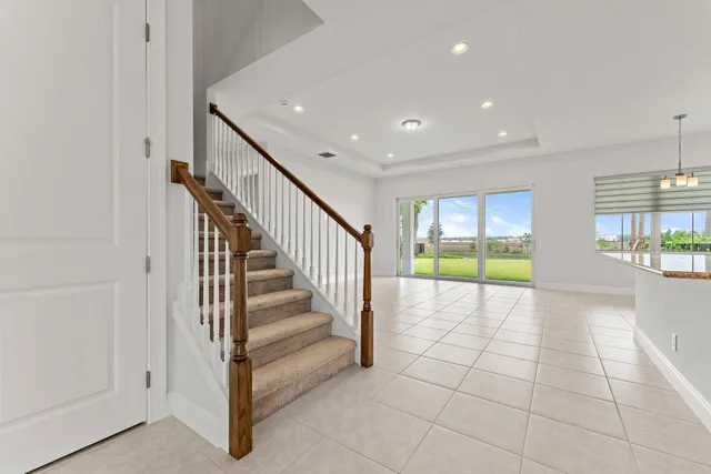 a large kitchen with kitchen island a large counter top stainless steel appliances and cabinets