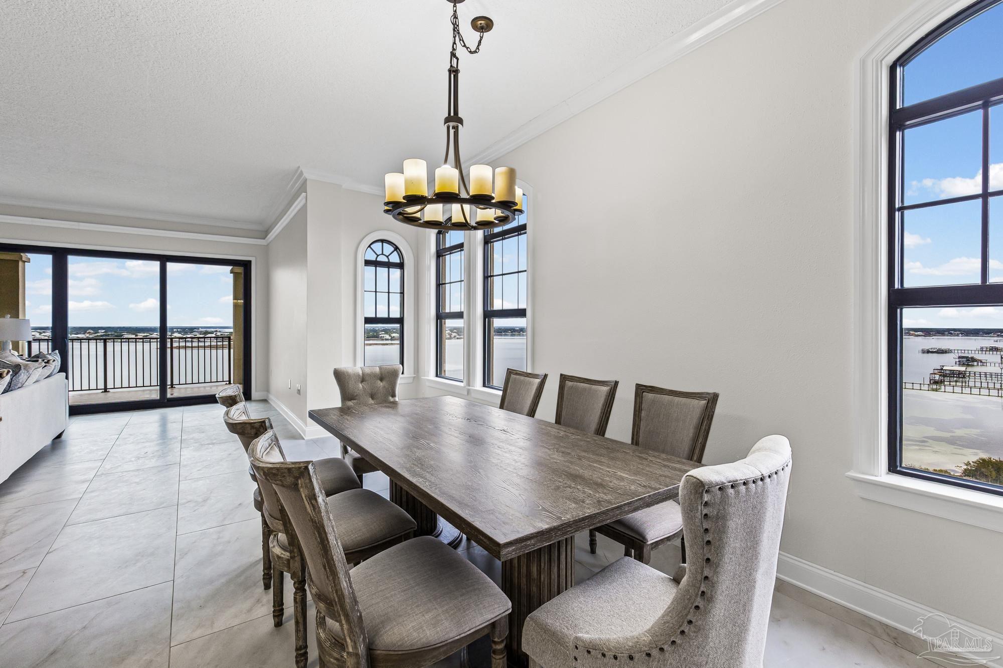 14900 River Road, Unit 904 Perdido Key, FL 32507 - Photo 11 of 62 a view of a dining room with furniture window and wooden floor