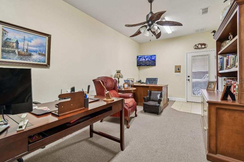 3302 Jap Tucker Road Plant City, FL 33566 - Photo 11 of 44 a room with furniture and a bookshelf
