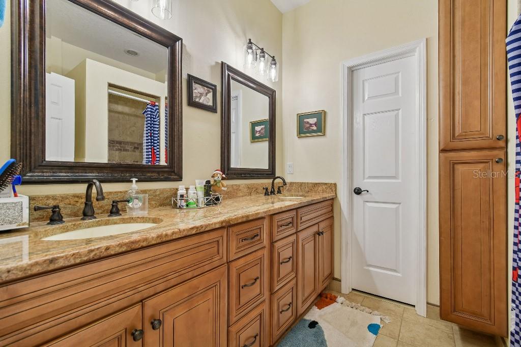 3302 Jap Tucker Road Plant City, FL 33566 - Photo 22 of 44 a bathroom with a double vanity sink and a mirror
