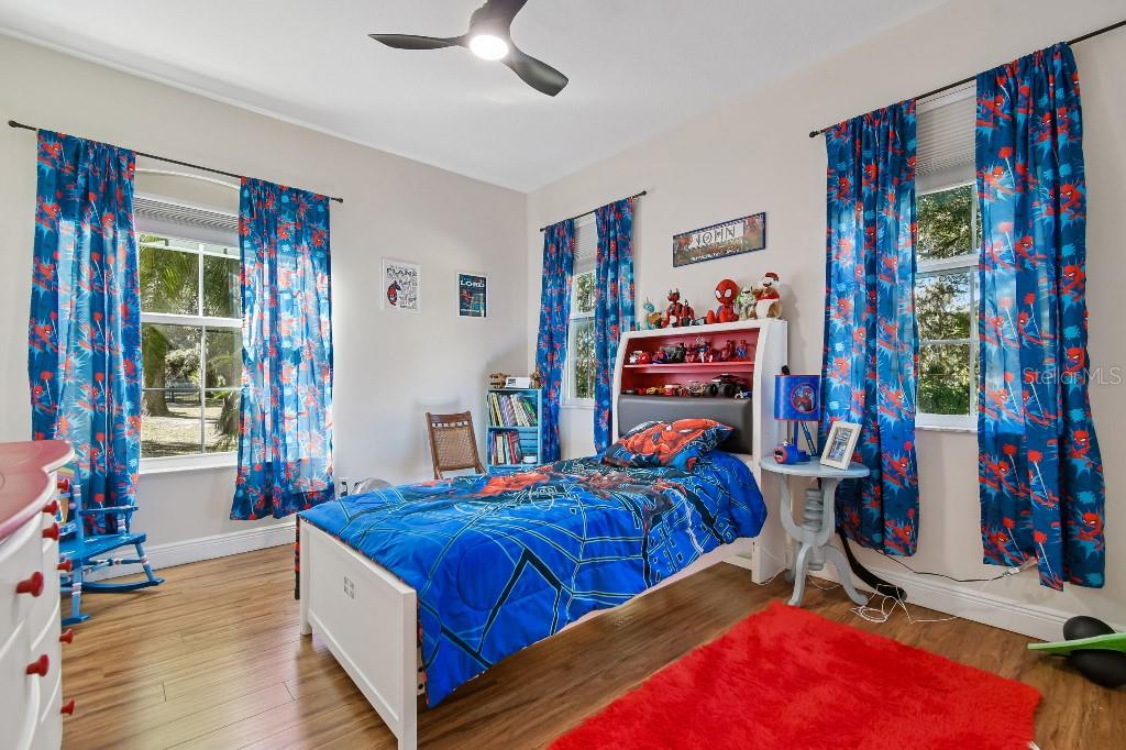 3302 Jap Tucker Road Plant City, FL 33566 - Photo 23 of 44 a bedroom with a bed and a book shelf