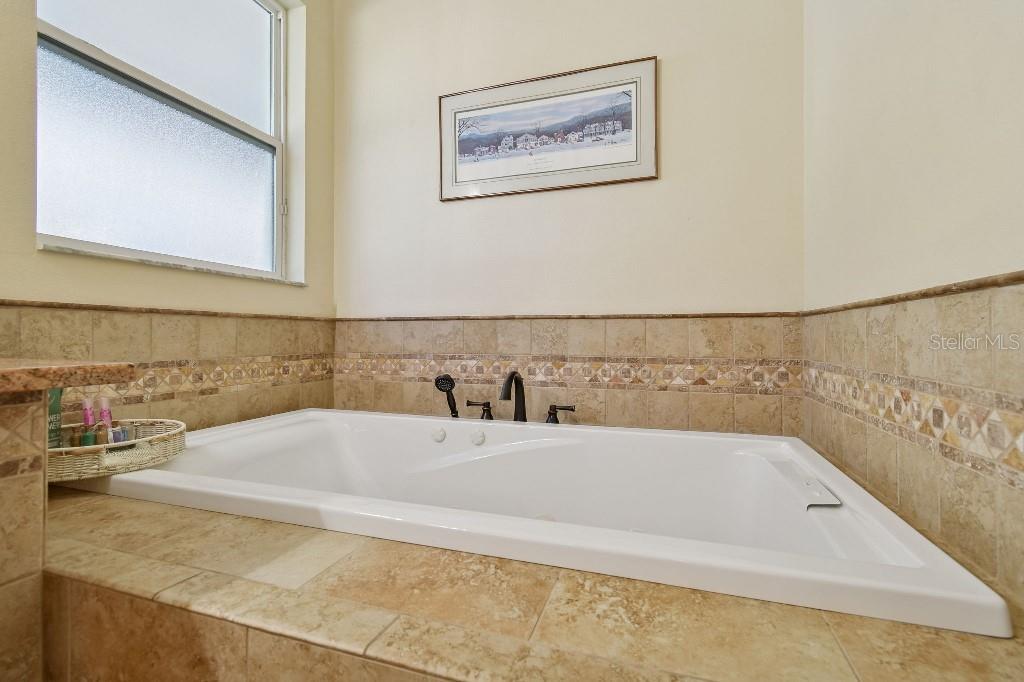 3302 Jap Tucker Road Plant City, FL 33566 - Photo 26 of 44 a white bath tub sitting next to a white sink
