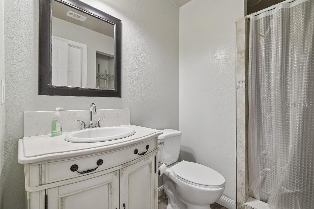 3302 Jap Tucker Road Plant City, FL 33566 - Photo 31 of 44 a bathroom with a sink toilet and mirror