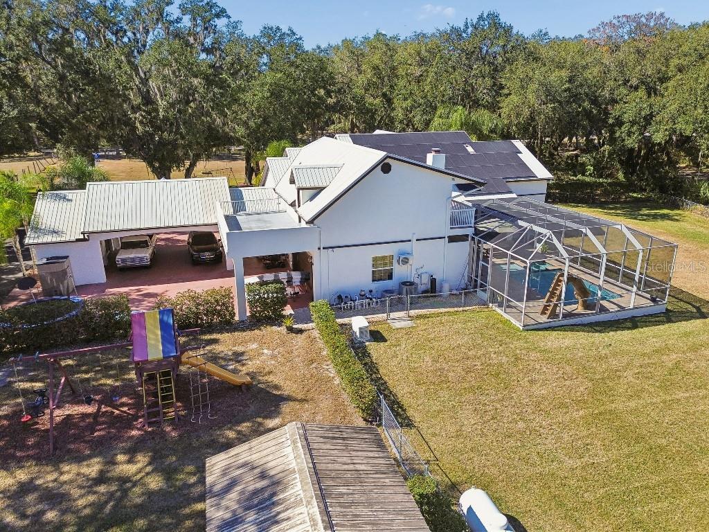 3302 Jap Tucker Road Plant City, FL 33566 - Photo 39 of 44 a view of a house with backyard patio and sitting area