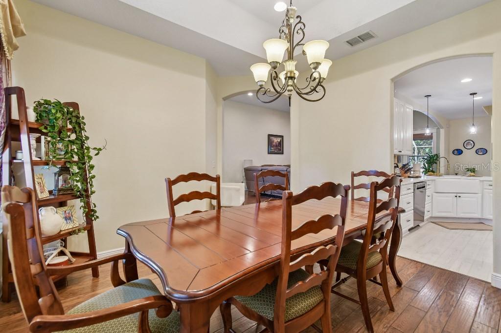 3302 Jap Tucker Road Plant City, FL 33566 - Photo 7 of 44 a view of a dining room with furniture and chandelier