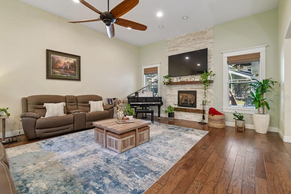 3302 Jap Tucker Road Plant City, FL 33566 - Photo 8 of 44 a living room with furniture a flat screen tv and a fireplace