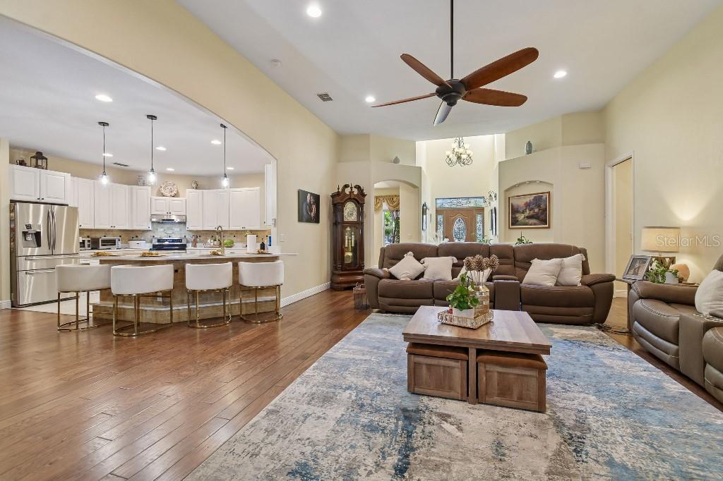 3302 Jap Tucker Road Plant City, FL 33566 - Photo 9 of 44 a living room with furniture kitchen view and a chandelier
