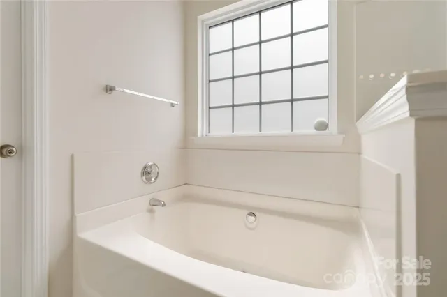 a white bath tub sitting next to a window