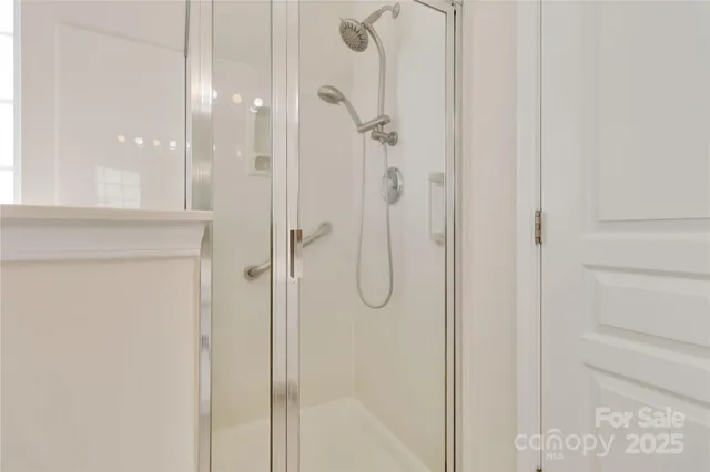 a bathroom with a glass shower door