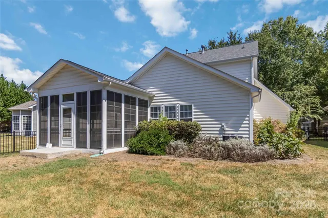 a front view of house with yard and trees around