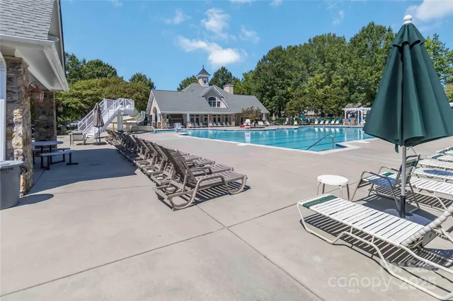a view of a patio with a table and chairs under an umbrella