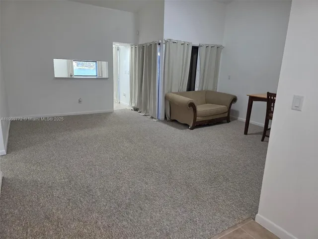 a living room with furniture and a large mirror