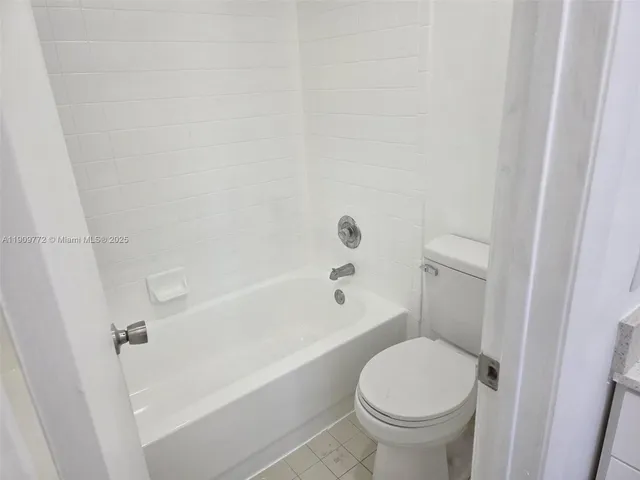 a bathroom with a toilet and a bathtub