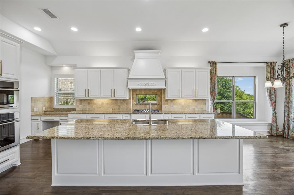 134 Santa Rosa Way Irving, TX 75062 - Photo 7 of 26 Bright, open kitchen with an oversized island, stainless steel appliances, and beautiful sightlines throughout the home.