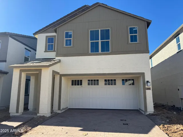 a view of a house with big yard and large tree