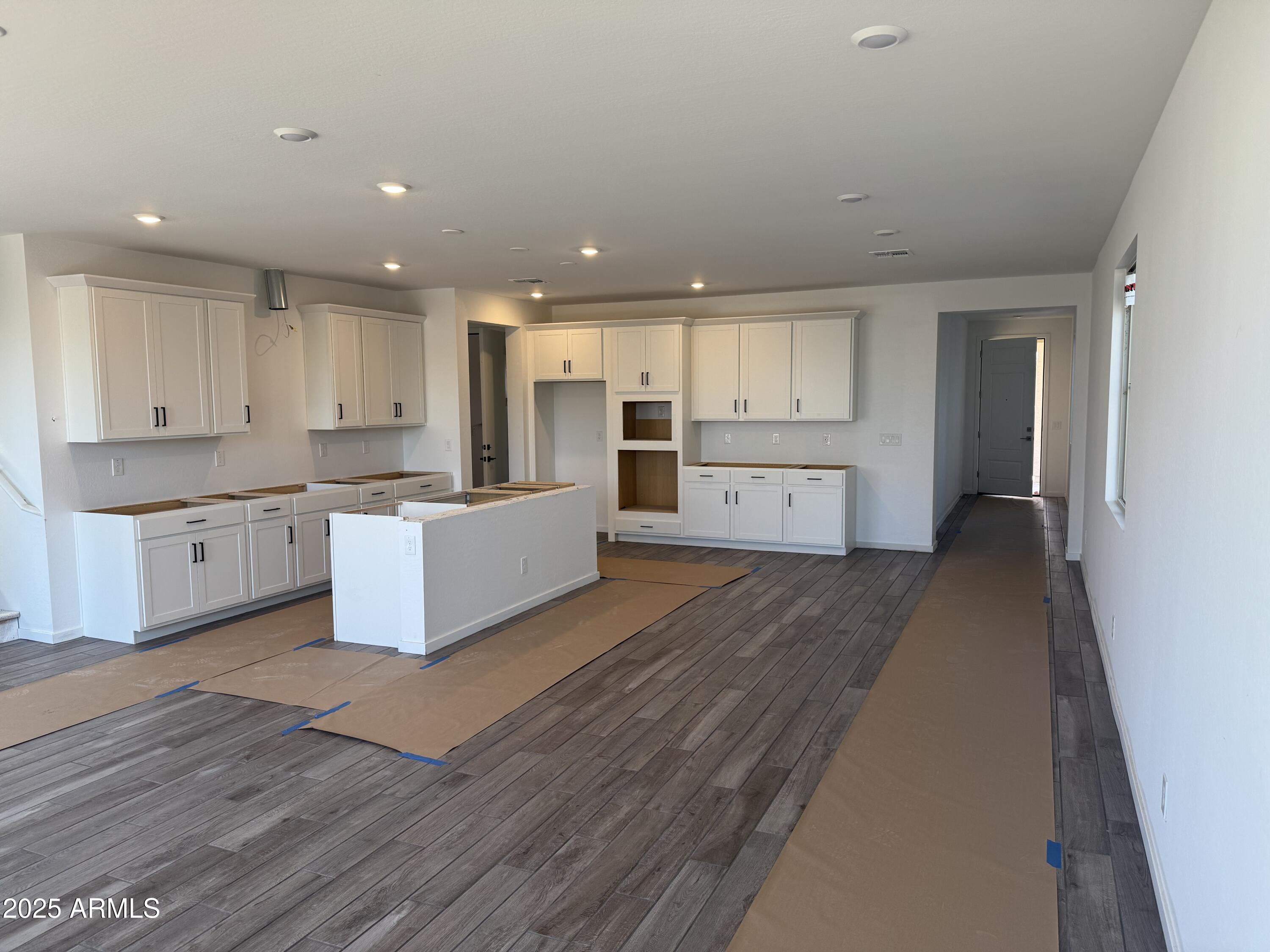2453 West Maximo Way Phoenix, AZ 85085 - Photo 3 of 19 a large kitchen with cabinets a sink and dishwasher a stove with wooden floor