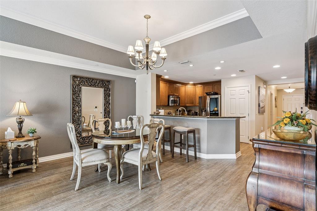 7656 Whisper Way, Unit 402 Reunion, FL 34747 - Photo 11 of 57 a view of a dining room with furniture window and wooden floor